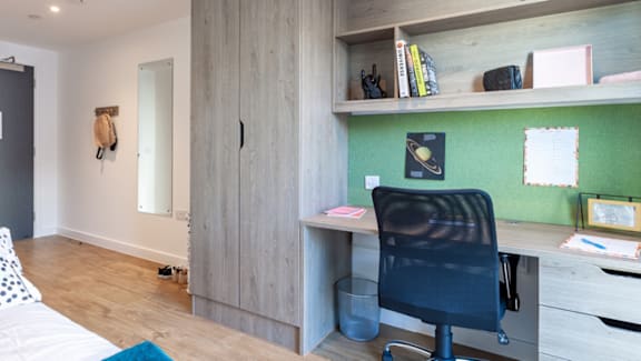 A room with a desk and a chair.
