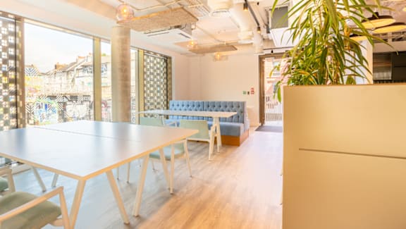 A conference room with a long table and chairs.