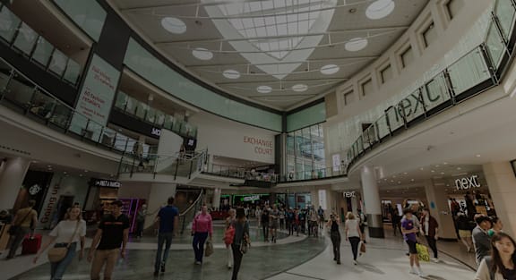 Shoppers are walking through the mall.