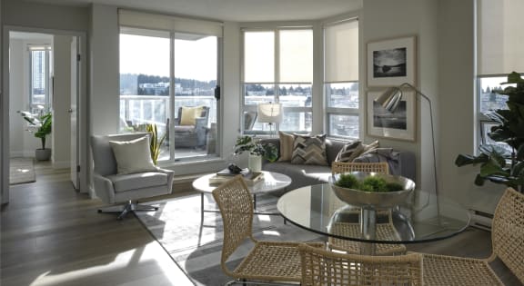 a living room filled with furniture and a large window