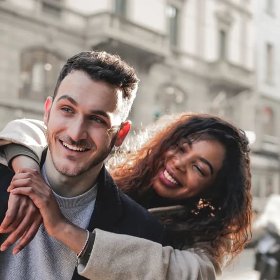 a man and woman walking down a city street