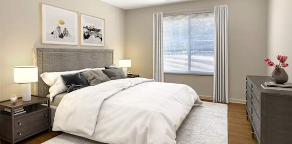 A bedroom with a large bed, two nightstands, and a window with curtains.