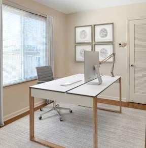 A conference room with a large table and chairs.
