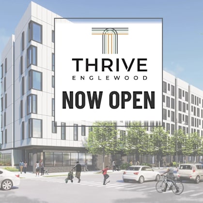 A modern building with the sign "Thrive Englewood" is now open.