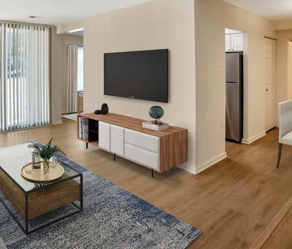 A modern living room with a flat screen TV mounted on the wall.
