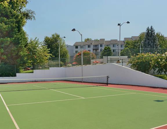 A tennis court with a net and no players.