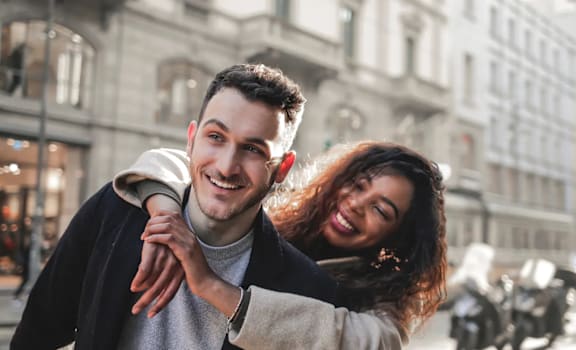 a man and woman walking down a city street