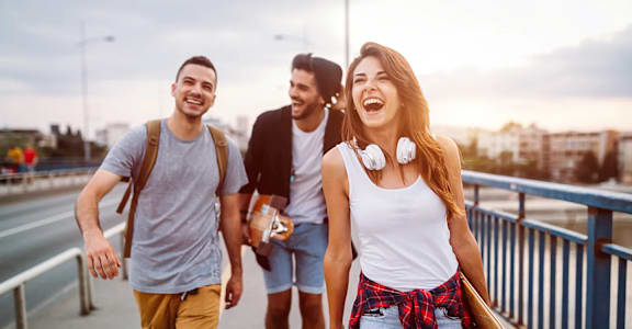 a group of friends walking across a bridge