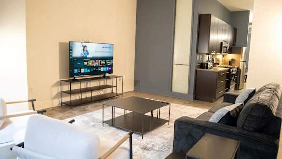a living room with a couch and a tv at Market Square Place, Pittsburgh, PA, 15222