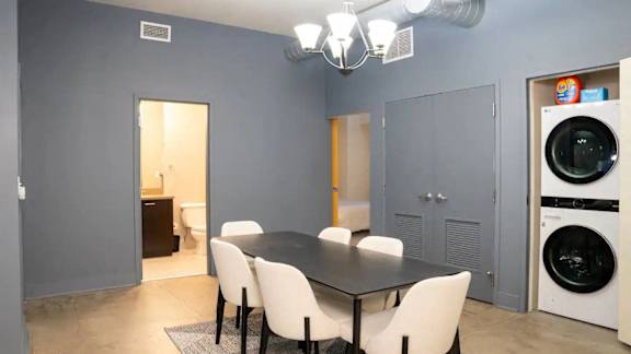 a dining room with a table and chairs and a washing machine at Market Square Place, Pittsburgh, PA, 15222