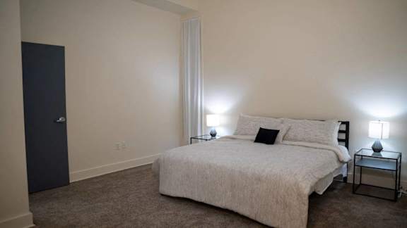 a bedroom with a bed and a black door at Market Square Place, Pittsburgh, PA, 15222