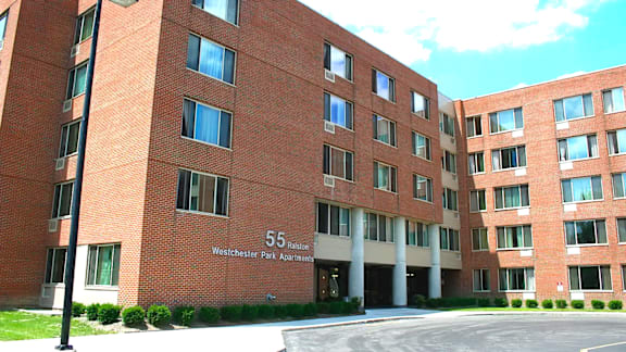 A red brick building with the number 55 on it.