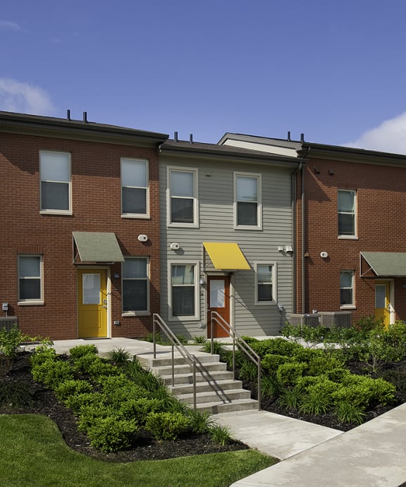 a row of townhouses on the side of a street