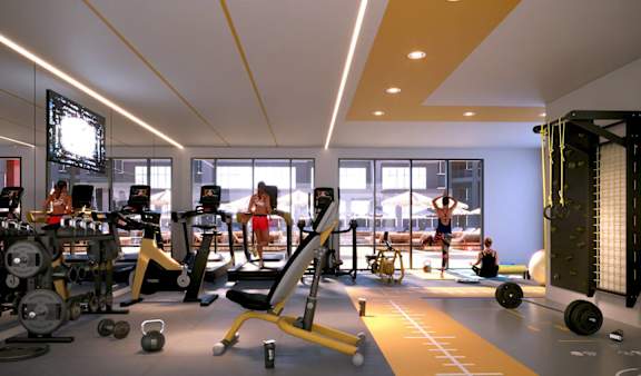A gym with a variety of equipment and people working out.