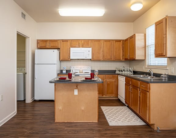 a living room with a kitchen and a balcony