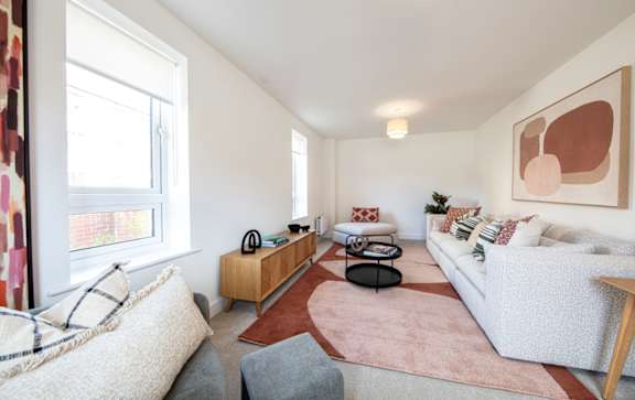 a living room with a couch and a glass table