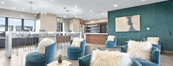 a living room with blue couches and a glass coffee table