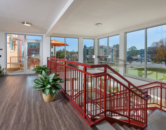 a large kitchen with a long island with chairs and a dining table