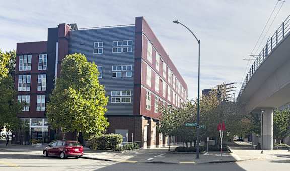 A red car is parked on the side of the street.