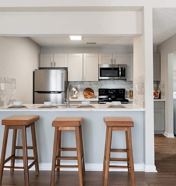 Kitchen with counter and stool at Station Heights Apartments in Alpharetta, GA, 30022
