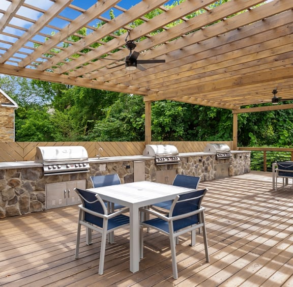 a patio with a table and chairs and a pergola