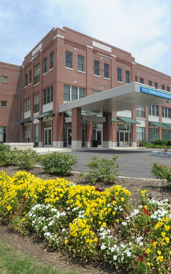a large brick building with flowers in front of it