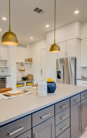 a large kitchen with stainless steel appliances and white cabinets