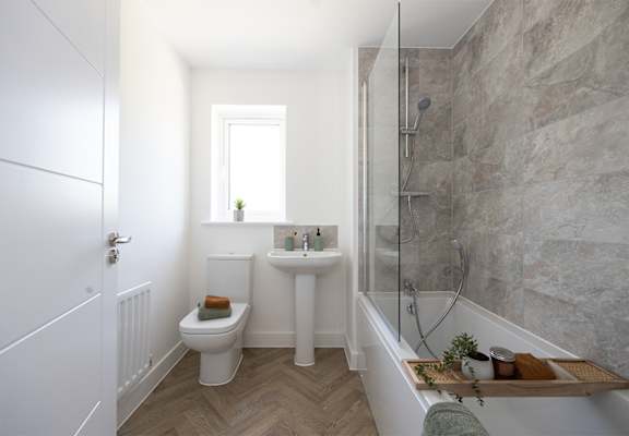 a white bathroom with a shower toilet and sink