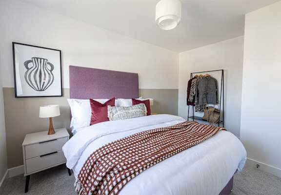 a bedroom with a bed and a dresser