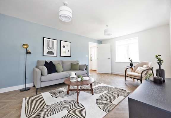 a living room with blue walls and a couch and a coffee table