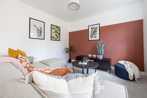 a living room with a couch and a glass table
