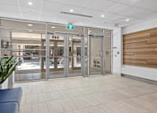 Thumbnail 3 of 4 - A set of double doors with a glass panel and a sign above it that says "EBS".
