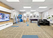 Thumbnail 5 of 5 - A room with a carpeted floor and a television on the wall.