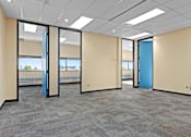 Thumbnail 9 of 13 - A room with a carpeted floor, a white ceiling, and a blue door.