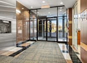 Thumbnail 2 of 9 - A hallway with a black and white checkered floor.