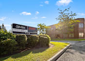 Thumbnail 6 of 6 - A sign for a property managed by Van Filtler is in front of a building.