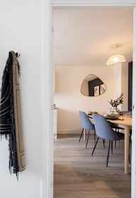 a modern kitchen with grey cabinets and black appliances