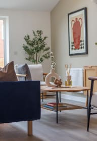 a modern kitchen with white cabinets and a dining area with a table and chairs