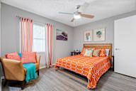 bedroom with hardwood-style flooring and ceiling fan