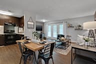 A kitchen and dining room with hardwood-style flooring