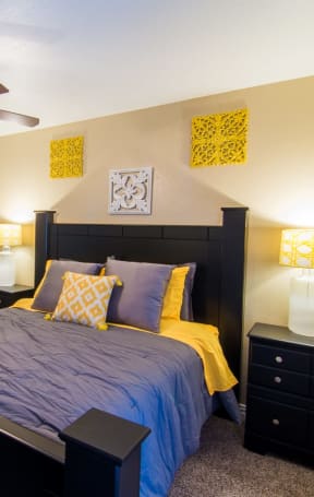 a bedroom with a bed and a ceiling fan