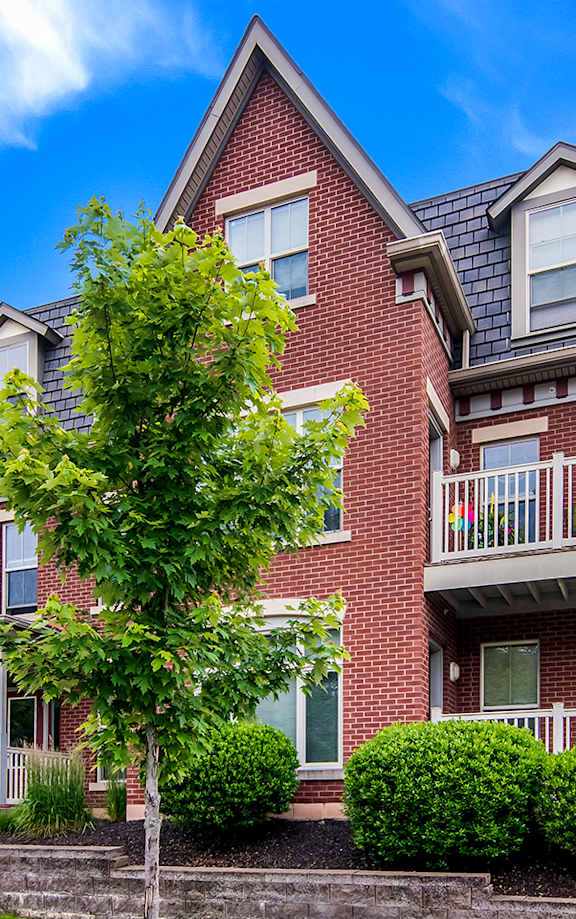 a row of houses with a sidewalk in front of them