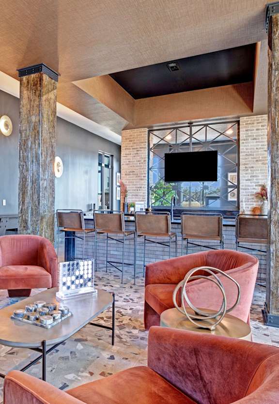 a lounge area with couches and chairs and a television