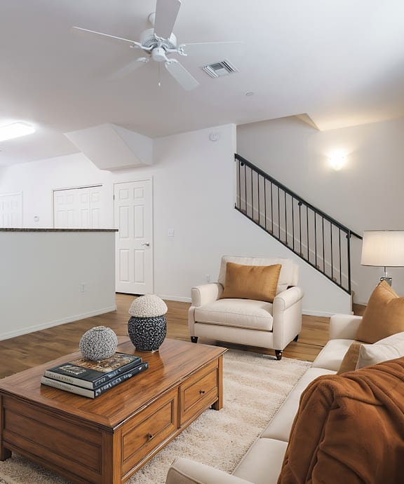 a bedroom with a bed with pillows and two lamps