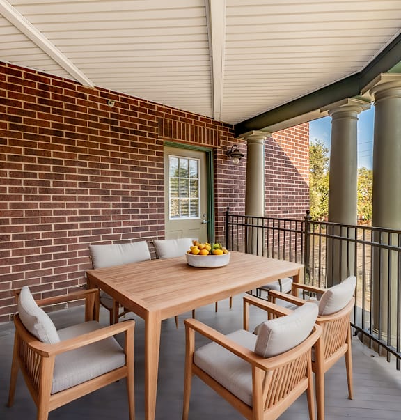 A table with chairs is on a balcony.