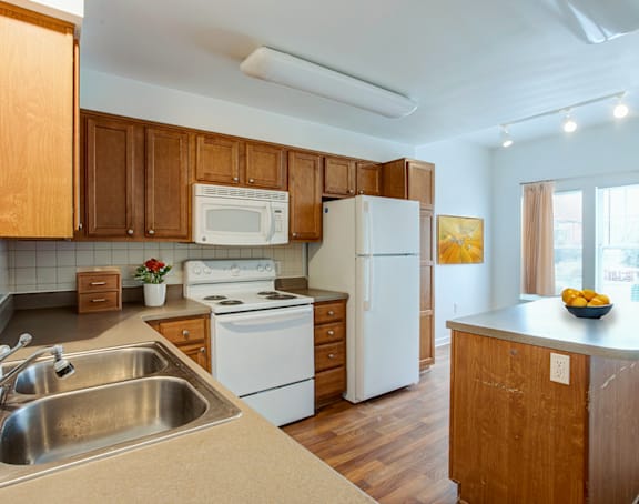 a living room with a kitchen and a balcony