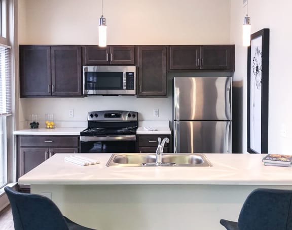 a living room with a kitchen and a balcony