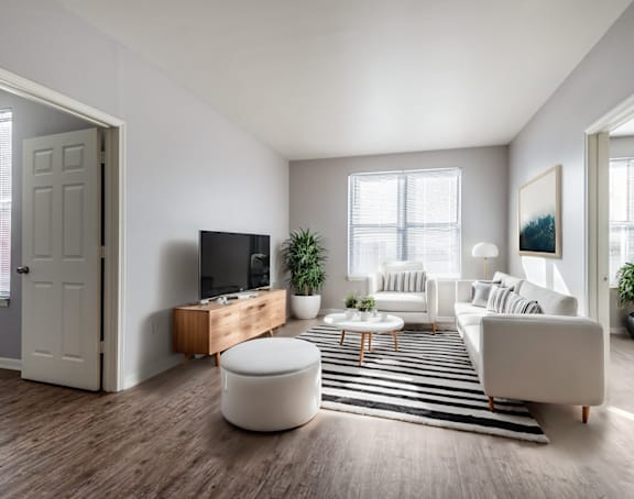 a living room with a kitchen and a balcony