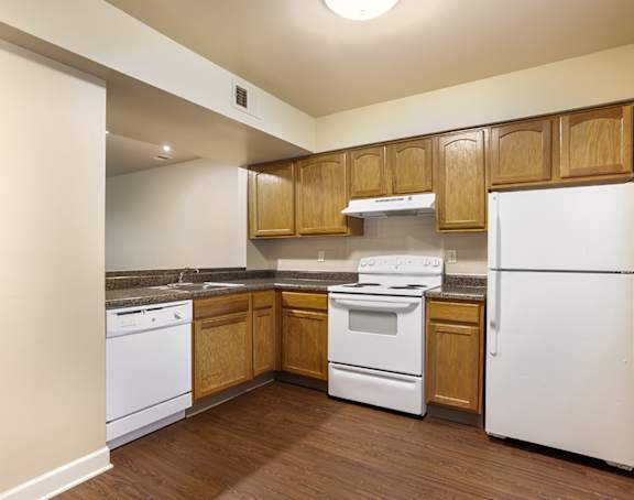 a living room with a kitchen and a balcony