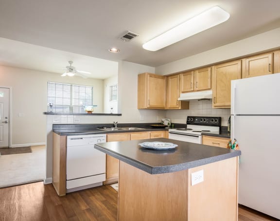 a living room with a kitchen and a balcony